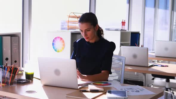 Female executive working at her desk in office 4k