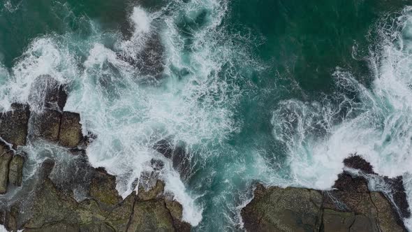 Waves Crash Against Rocks in the Ocean