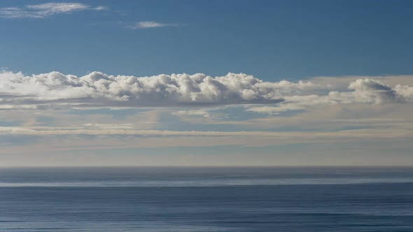 Clouds Moving Through A Beautiful Blue Sky Over The Ocean