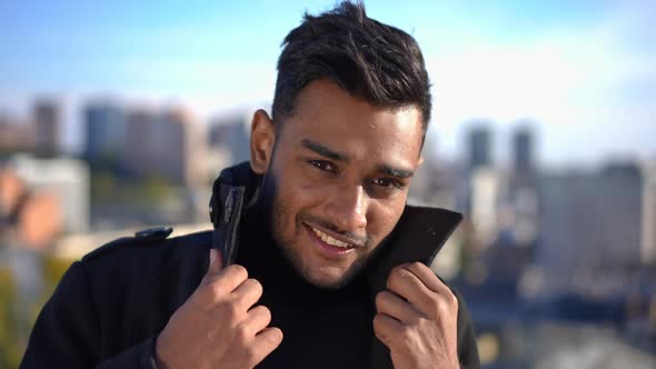 Closeup Confident Handsome Young Man with Brown Eyes and Black Hair Smiling Looking at Camera