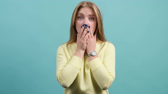 Attractive Girl Having Stunned and Shocked Look on a Turquoise Background.