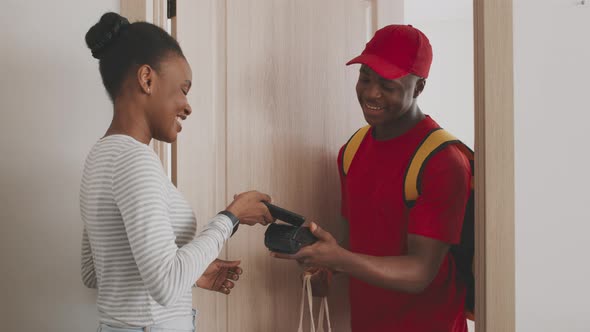 Cheerful African American Lady Paying for Food Order with Mobile Contactless Payment App and Getting