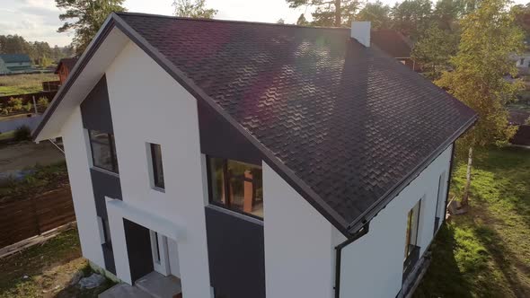 Roof of house made of soft tiles with chimney. 43