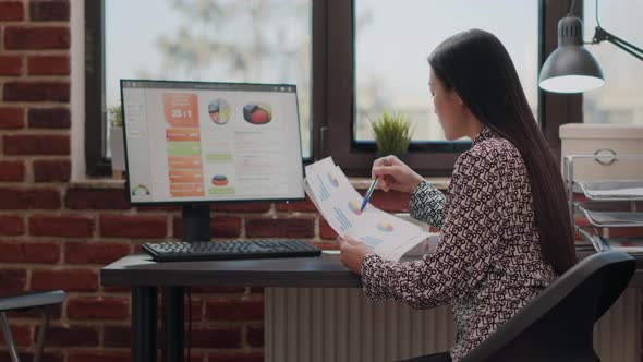 Business Woman Working on Financial Paperwork with Files