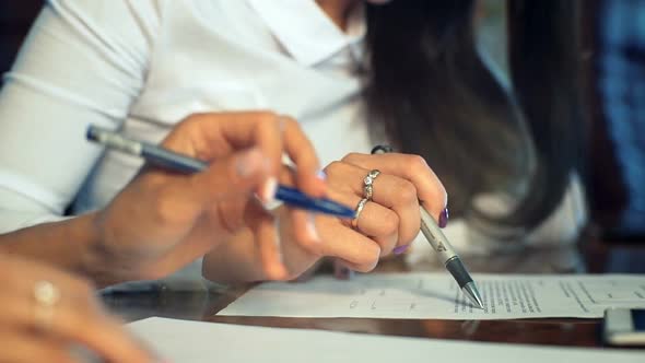 Closeup of Female Hands Making Notes in the Notepad at Office During Interview