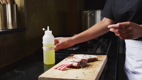 Mixed race male chef preparing a dish and smiling