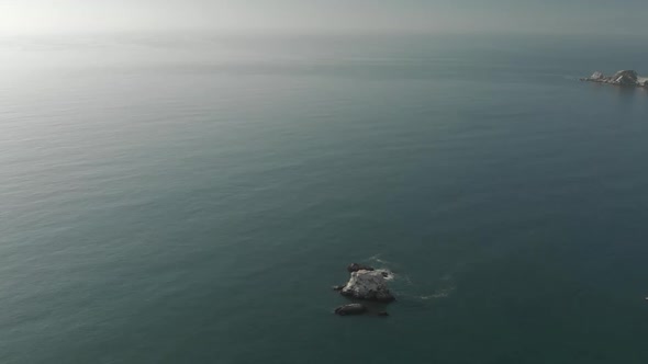 Aerial of Rock in Expansive Ocean