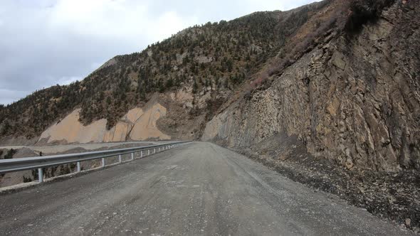 Off road car running on snowing mountain trail on winter day