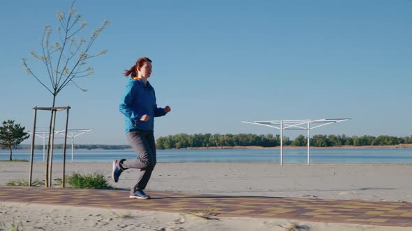 Jogger Running Along Beach in the Morning