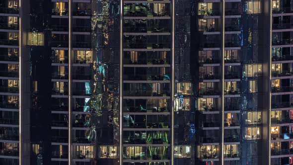 Windows in Apartments of a High Class Building at Night Timelapse