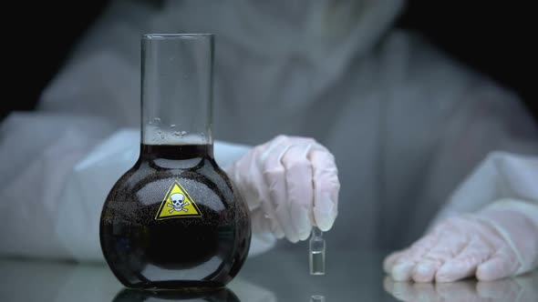 Medical Worker Putting Ampule With Antidote on Table Near Poison in Flask