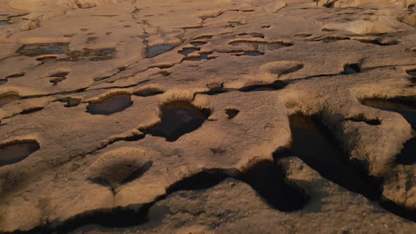 Close-up view of a scenic seashore with huge flat rocks  in the beautiful light of the setting sun,