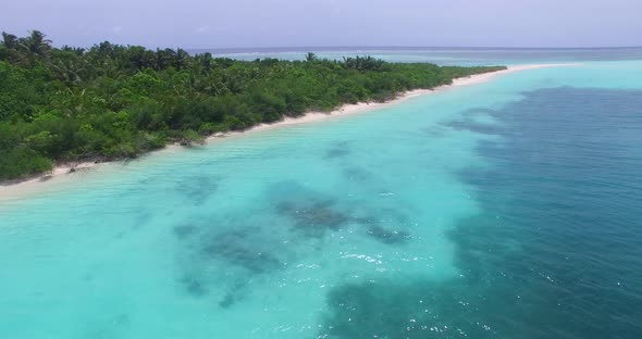 Tropical overhead abstract shot of a white paradise beach and aqua blue water background in vibrant 