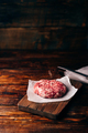 Raw beef patty for burger on cutting board - PhotoDune Item for Sale