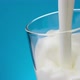 Pouring Milk in Glass Against Blue Background Slow Motion - VideoHive Item for Sale