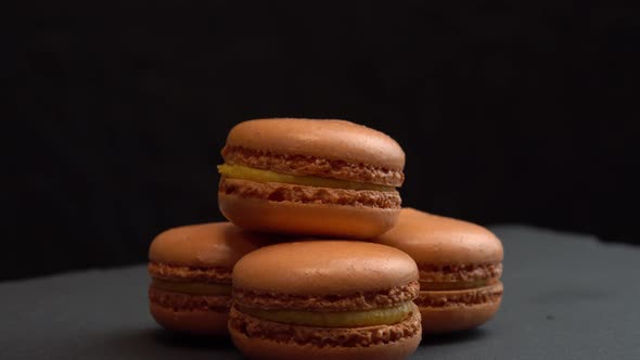 Macaroon Candy Rotate on a Black Surface for Background Sweets are Spinning Macro