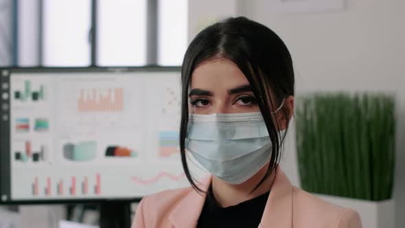 Closeup of Businesswoman Wearing Medical Face Mask to Avoid Virus Infection