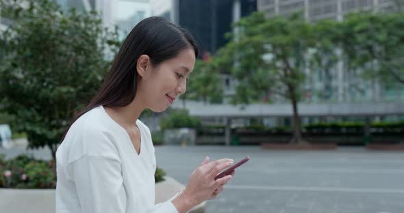 Woman work on smart phone in city