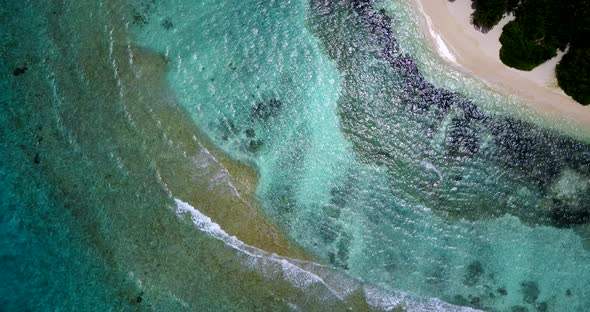 Daytime above clean view of a sunshine white sandy paradise beach and blue water background in best 