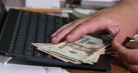 Hands of Man Accountant Counting Dollar Banknotes with Credit Card for Making Payment Transaction