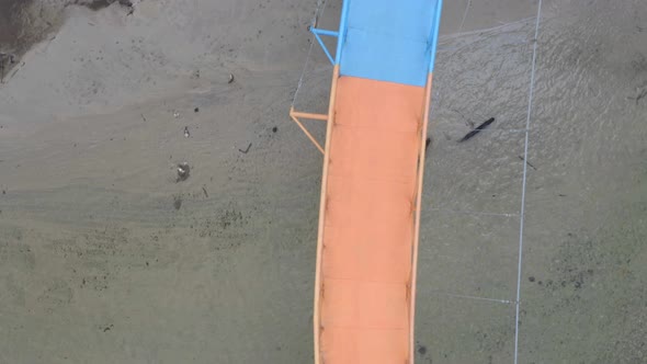 Aerial top view of a bright colored pedestrian bridge