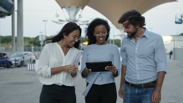 Three Colleagues Walking Somewhere Slowly with Tablet, Then Standing