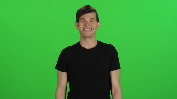 Young man smiling relaxed while walking