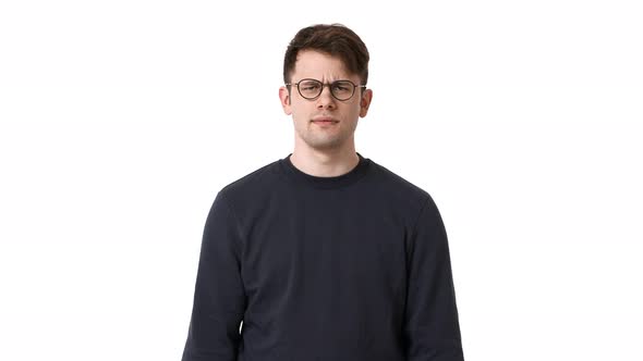 Portrait of Caucasian Guy Wearing Black Sweatshirt and Eyeglasses Asking Keep Quiet Putting Index