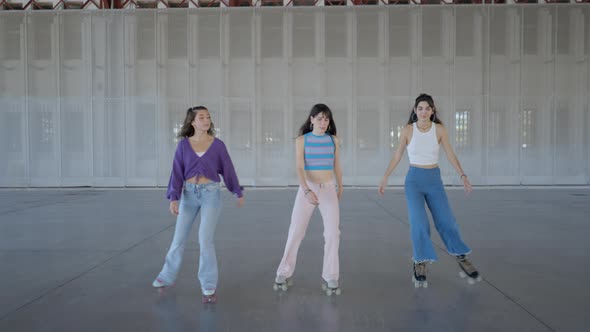 Backing Shot Following Three Young Women Roller Skating Slomo