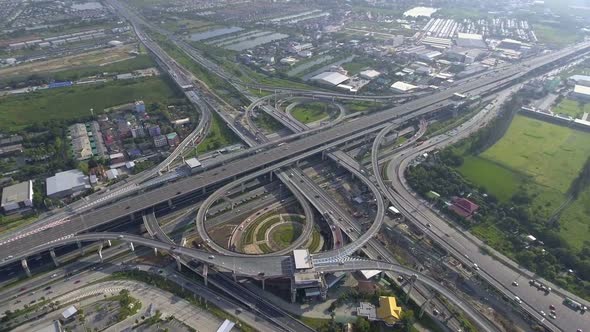 Aerial View of Highway Road Interchange with Busy Urban Traffic Speeding on Road