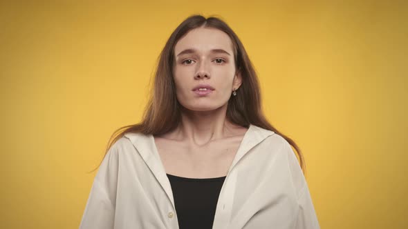 Woman Taking a Deep Breath and Exhale on a Bright Yellow Background