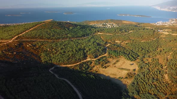 Flying Over of Agricultural Landscape with Many Fields Farmlands Sea and Mountain Background