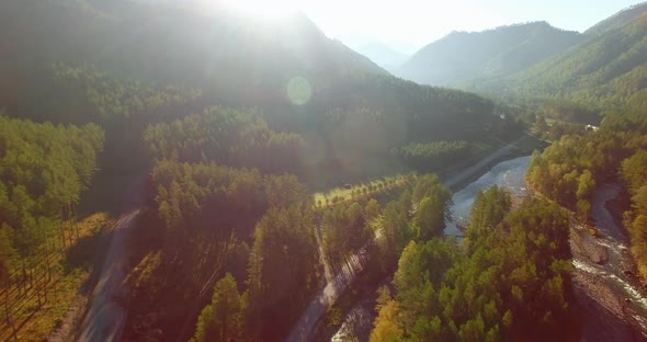 Mid Air Flight Over Fresh Mountain River and Meadow at Sunny Summer Morning