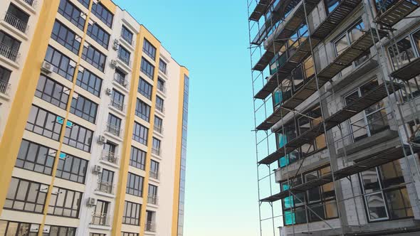 Aerial view of high residential apartment building under construction. Real estate development.