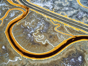 e. A winding road and the landscape of the salt flats.