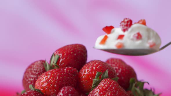 Strawberry Yogurt in a Spoon, Against the Background of Fresh Strawberries