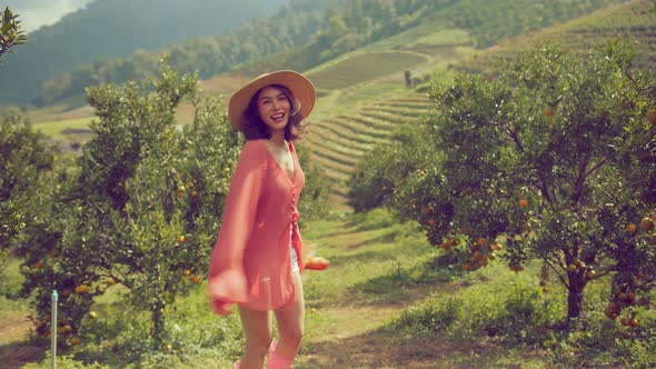 young beautiful attractive asian woman wearing casual colorful dress