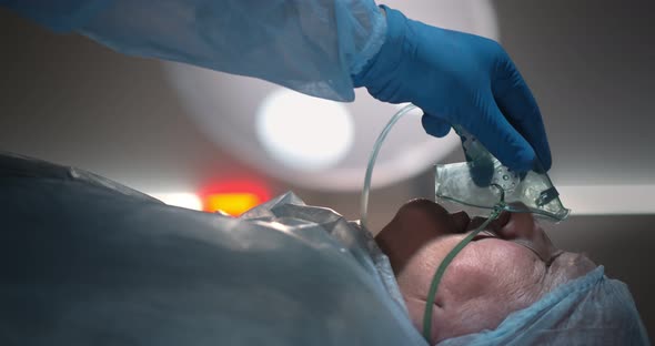 Close Up of Doctor Giving Anesthesia to Patient Before Surgery