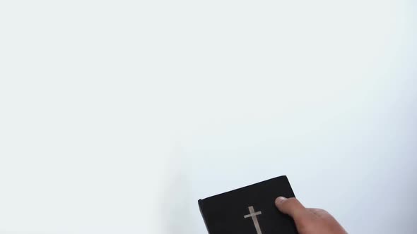 Male Hands Holding Bible, Praying to Appeared God on Background, Salvation