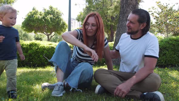 Family Spends Time in a Green Park