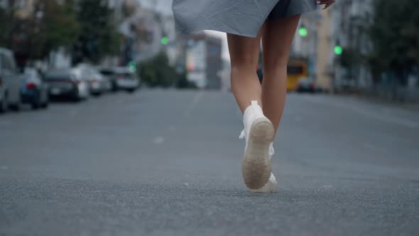 Legs Walking Down Street on Highway Road