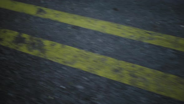 Closeup Cinematic POV Shot of an Wet Asphalt Road