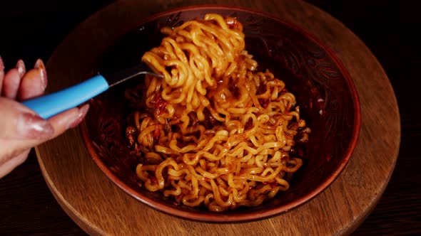 Readymade Instant Noodles with Condiment and Spicy Sauce in Plate on Wooden Board