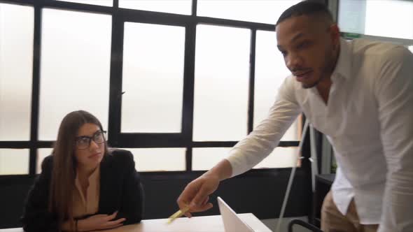 Young business people having team meeting at coworking space