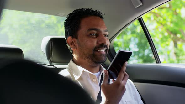 Male Passenger Calling on Smartphone in Taxi Car