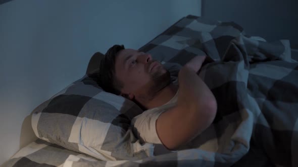Dissatisfied Man Turning in Bed at Night Insomnia Problems Sleeping Disorder