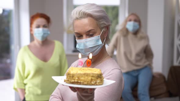 Portrait of Caucasian Woman in Coronavirus Face Mask Posing with Cake and 50 Years Candles on It