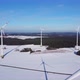 Aerial shot of a windfarm in a snowy winter landscape. Flying through a wind farm. - VideoHive Item for Sale