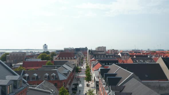 Forward Slow Flight Through Torvegade Street in Esbjerg Denmark with Pedestrians Strolling Downtown