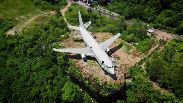 White Airplane on Brown Earth in Green Tropical Bushes